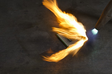 Image showing burning a computer chip with welding torch