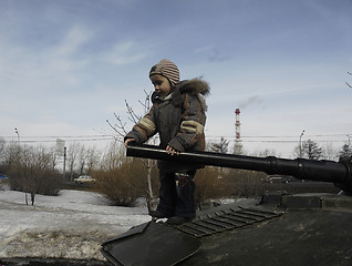 Image showing Kid on a tank