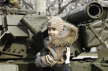 Image showing Kid on a tank