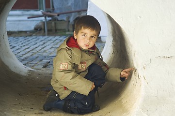 Image showing Little kid in a stone tube