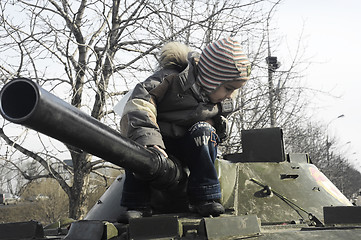 Image showing Kid on a tank