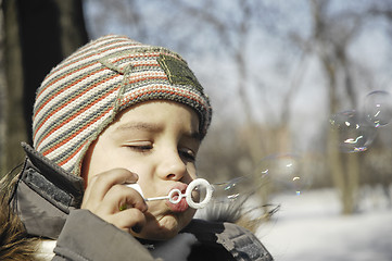 Image showing BOY BLOWING BUBBLES