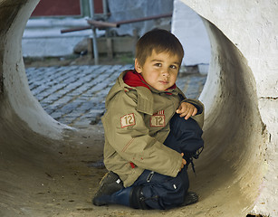 Image showing Little kid in a stone tube