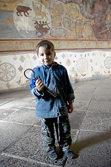 Image showing Boy in church with big old key