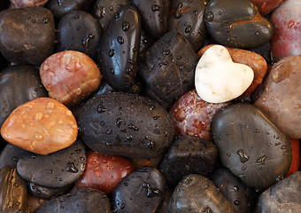 Image showing White stone heart surrounded by other stones