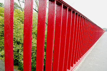 Image showing Bridge railing painted red background closeup 