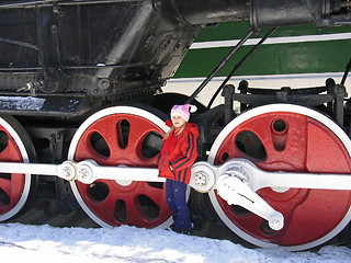 Image showing girl and wheels of old locomotive