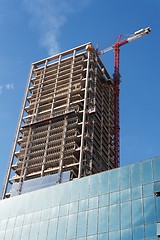 Image showing Lifting crane and high building under construction