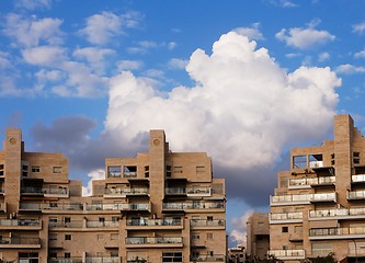 Image showing New apartment buildings and clouds above them at sunset