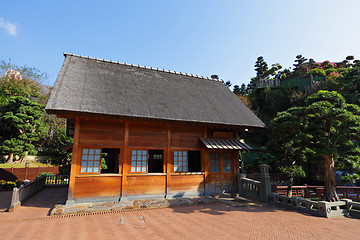 Image showing wooden hut with tree and blue sky