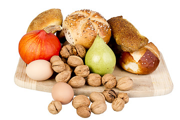 Image showing gem, nuts, eggs and a pine on a wooden board