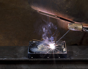 Image showing repairing a defect hard disk with welding apparatus