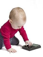 Image showing young child in white background with hard drive