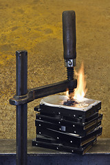 Image showing burning stack of hard drive pressed together with clamp