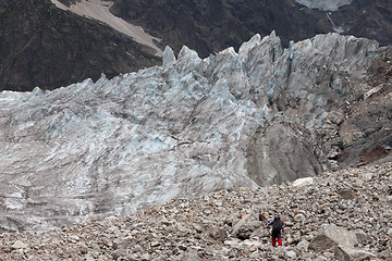 Image showing Hiker on glacier moraine