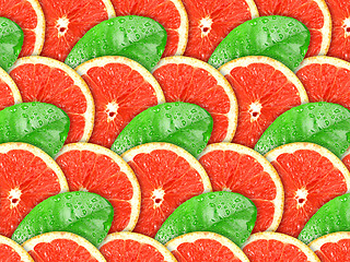 Image showing Background of grapefruit slices and green leaf