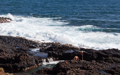 Image showing Two boys looking to jump into ocean