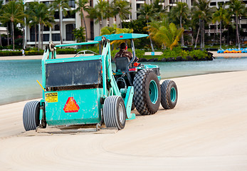 Image showing Sweeping and raking sand on beach