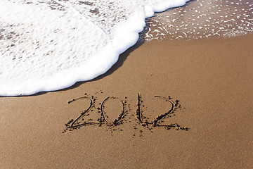 Image showing 2012 written in sand with waves