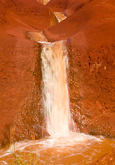 Image showing Cascading river in dry red rocks