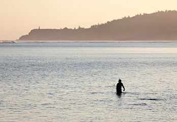 Image showing Misty sunrise with snorkler