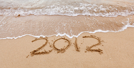 Image showing 2012 written in sand with waves