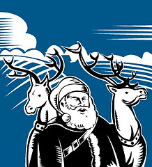 Image showing Father Christmas Santa Claus with reindeer 