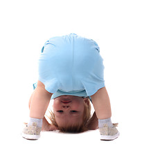 Image showing Little boy stands upside-down