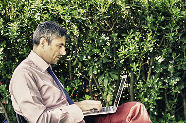 Image showing Manager in the Garden with his Notebook