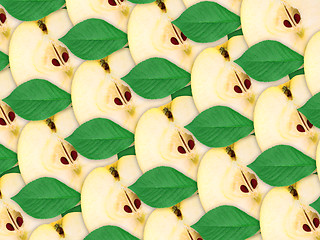 Image showing background of apples slices and green leaf