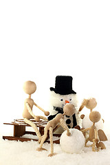 Image showing Parents with children building a snowman