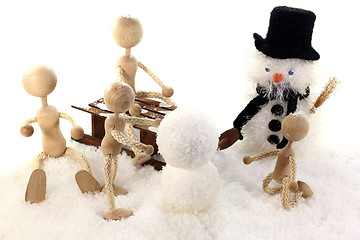 Image showing Family builds a snowman