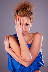 Image showing beautiful woman covering half face, with his hands, studio shot
