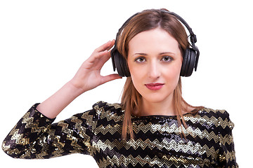 Image showing beautiful woman standing listening to music on black headphones