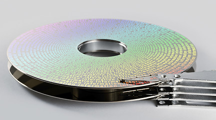 Image showing parts of hard disk drive with information on magnetic surface