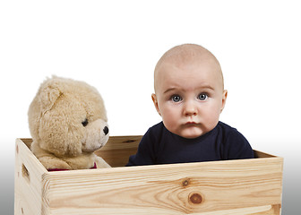 Image showing young child with toy in wooden box