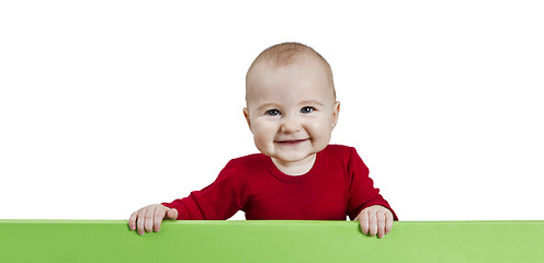 Image showing young child holding green sign