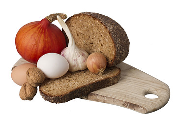 Image showing brown bread on shelf with onion, garlic and walnut