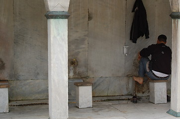 Image showing Washing feet before prayer
