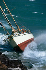 Image showing yacht crash on the rocks in stormy weather 