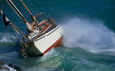 Image showing yacht crash on the rocks in stormy weather 