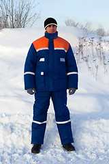 Image showing Worker in the winter suit consisting of a jacket and trousers