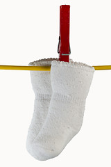 Image showing baby sox on clothesline with clothespin