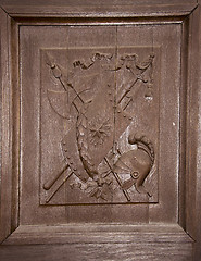 Image showing wooden carved door coat arms helmet shield swords 