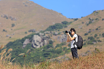 Image showing photographer taking photo in country side