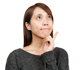 Image showing Thinking woman looking up