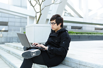 Image showing man using computer outdoor
