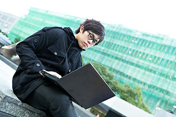 Image showing man using computer outdoor