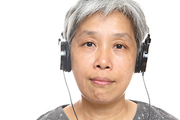 Image showing mature woman listen music