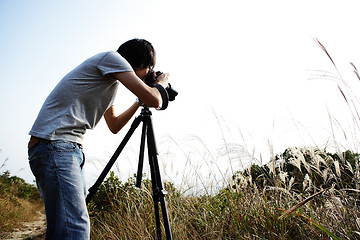 Image showing photographer taking photo in country side